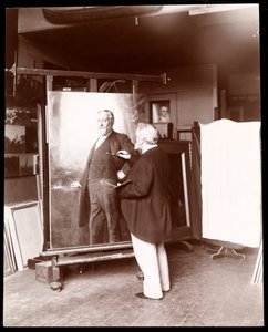 Eastman Johnson avec pinceau à la main, travaillant sur le portrait du président Harrison dans son studio, New York, 1895